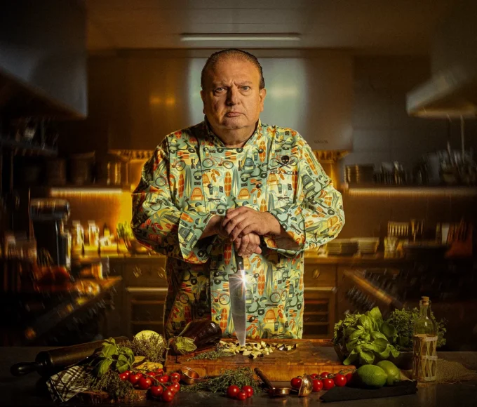 Erick Jacquin posando com faca em tábua na arte oficial da 5a temporada de Pesadelo na Cozinha